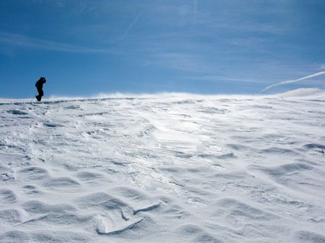 Snowy mountains in the pyrenees, Spain. with lonely hiking person