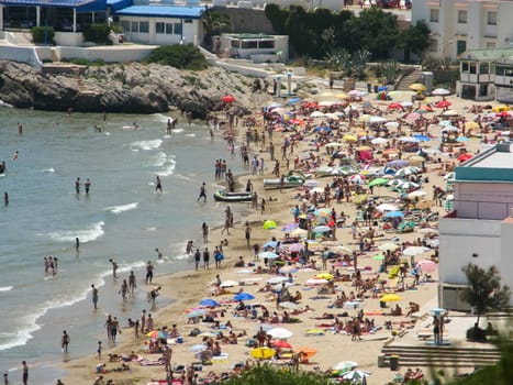 small beach full of people on the coast of spain