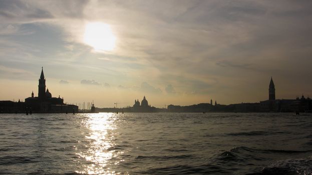 Silhouette of venice seen from the water in the late afternoon
