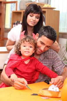 Parents and child preparing for Halloween