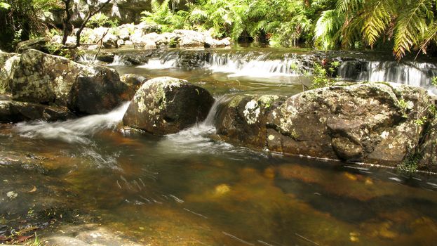 water flow around stones in a small river in australia, water fall