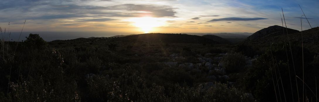 Panorama view from the Natural Park of Garraf with a hill or  mountain, sea, and sunset