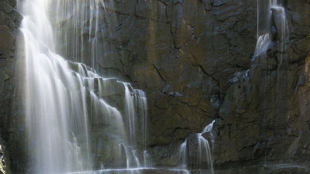 detail of a waterfall in long exposure and rocky background