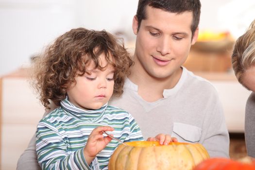 child emptying pumpkin