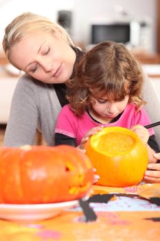 Woman and girl with pumpkins
