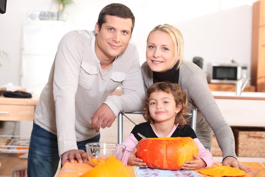 Parents with a child and pumpkin