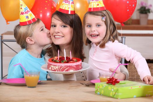 Mum and kids with birthday cake