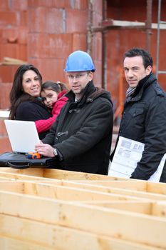 Family visiting unbuilt house