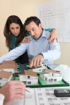 Architects gathered around model replica of housing estate