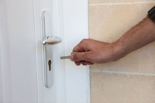 Man putting a key in his front door