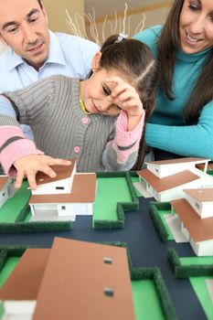 Young family looking at model house