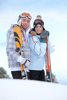 Couple about to ski down mountain