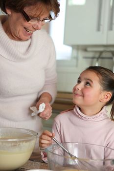 Little girl cooking with grandma