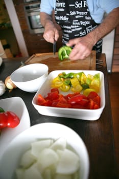 Man chopping peppers