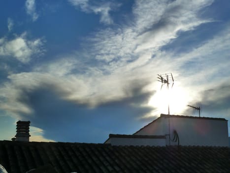 whispy white clouds and the bright sun