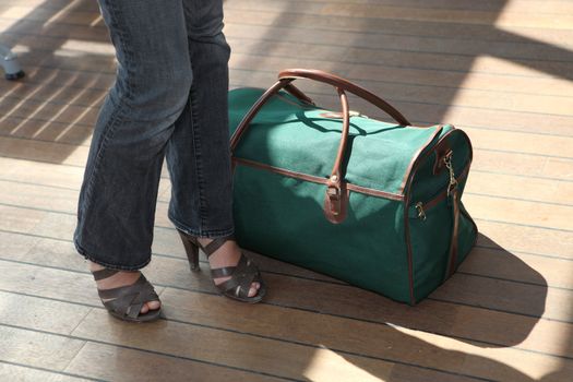 Woman stood next to baggage