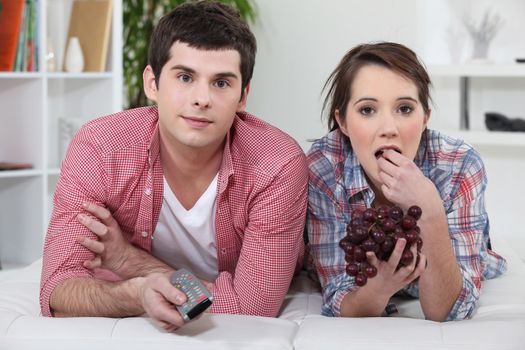 Young couple watching television