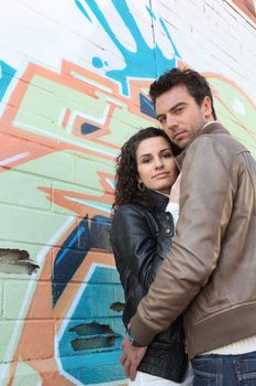 Couple stood in front of a wall