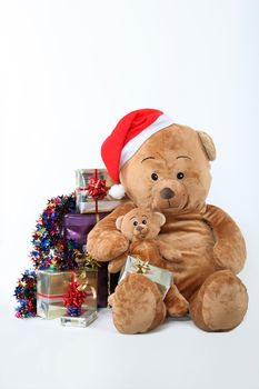 teddy bear surrounded by Christmas gifts