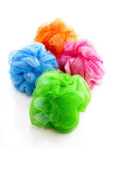 Four colorful shower scrubbers