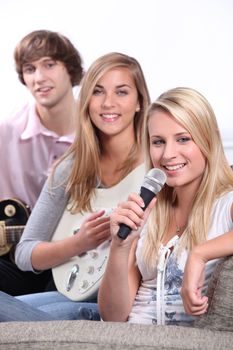 group of teenagers playing music at home