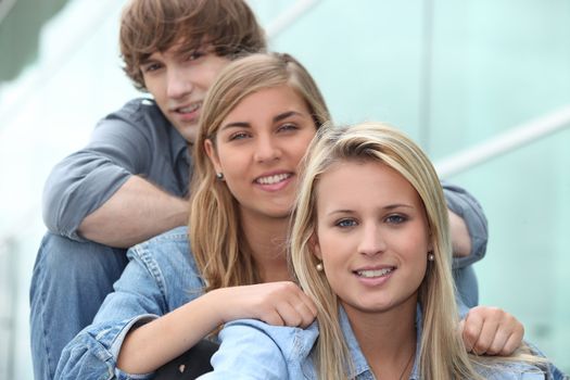 three students sitting in line