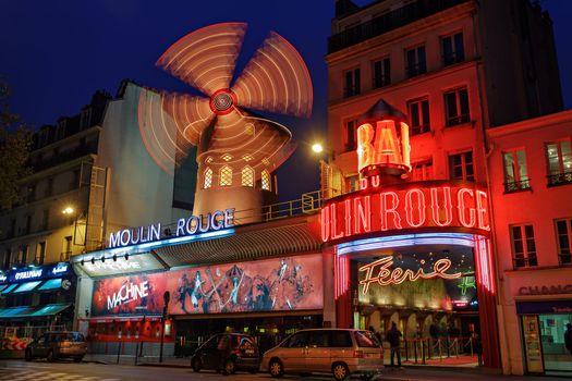 PARIS - NOV 12: The Moulin Rouge by night, on November 12, 2012 in Paris, France. Moulin Rouge is a famous cabaret built in 1889, locating in the Paris red-light district of Pigalle
