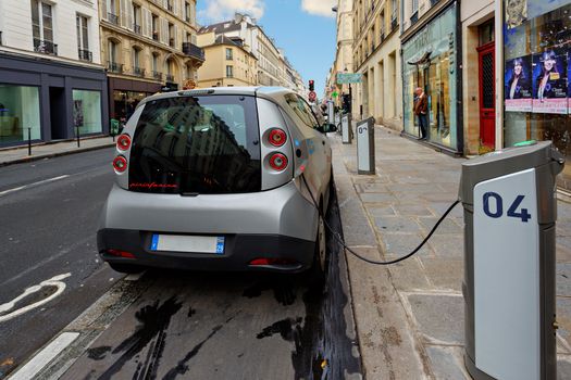 PARIS - NOV 13: Electric vehicle in car sharing station. This innovative service allows to pick up and deposit cars in various parking areas around the city, on November 13, 2012 in Paris, France