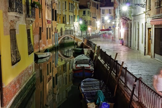 Narrow canal in Venice at night Italy