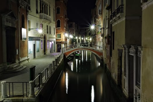 Narrow canal in Venice at night Italy