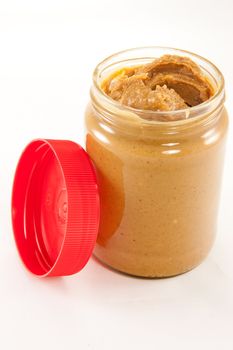 Picture of a jar of delicious peanut butter with a lid
