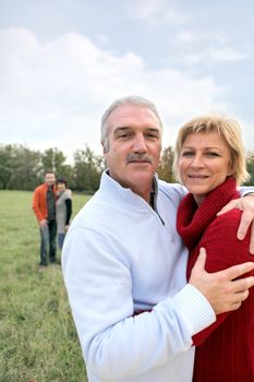 Two generations stood in field