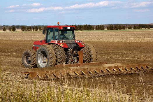 Tractor cultivated field in early spring