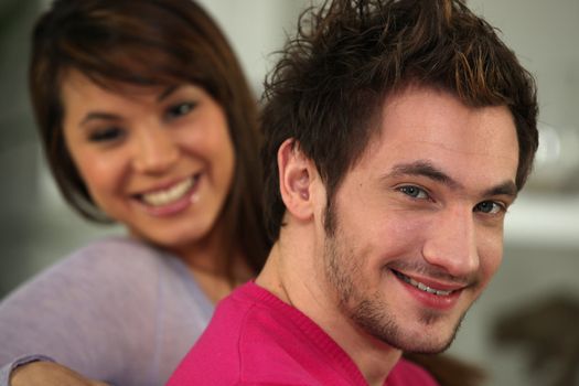 Profile shot of young couple relaxing on their sofa