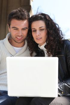 Couple looking at their laptop