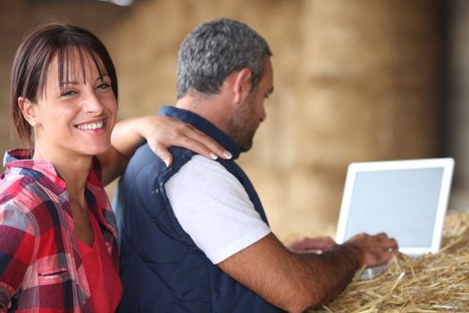 A middle age couple in their farm.