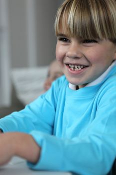 Little boy giggling in class