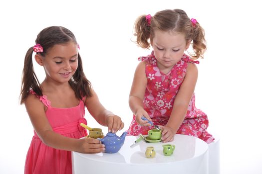 Little girls playing, studio shot