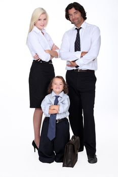 Man and woman in smart suit and little boy dressed as a businessman