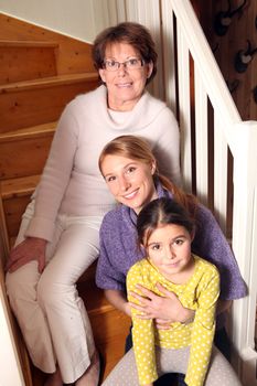 grandmother, mother, and daughter sitting on stairs