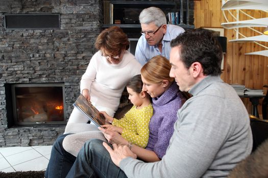 Family at home around a fireplace