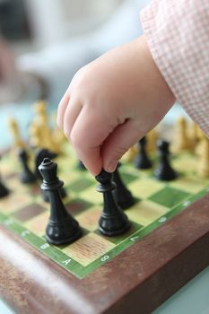 Clever little girl playing chess