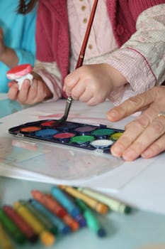 Close-up shot of creative child painting