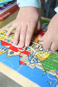 Toddler completing puzzle