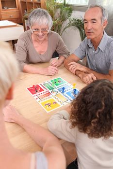 Family playing board game together