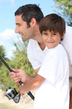 Man and little boy fishing