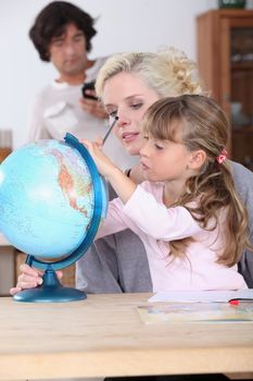 Mother and daughter looking at globe