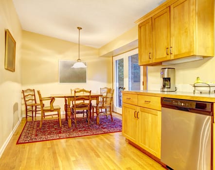 Kitchen in orange warm colors and dining room.