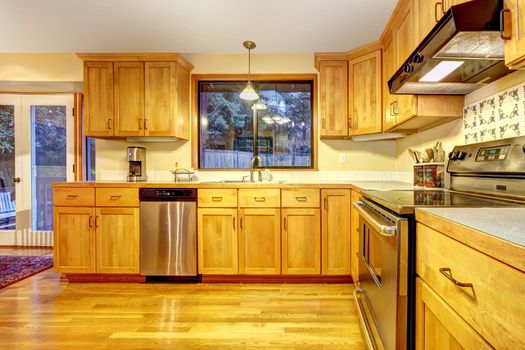 Golden orange kitchen with hardwood floor.