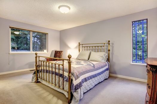 SImple blue bedroom with metal bed.